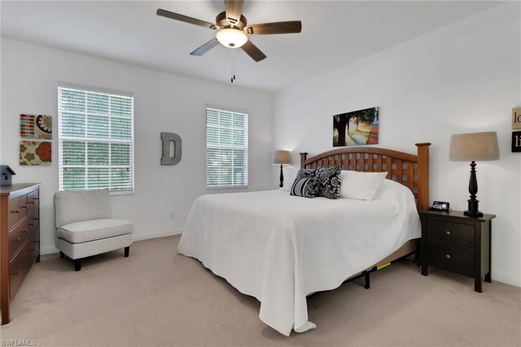 3570 Zanzibar Way Naples, FL 34119 - Photo 18 of 43 a bedroom with a bed and a chandelier