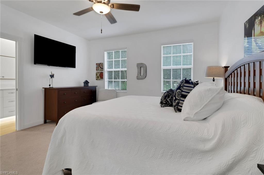 3570 Zanzibar Way Naples, FL 34119 - Photo 19 of 43 a bedroom with a bed a window and a flat screen television