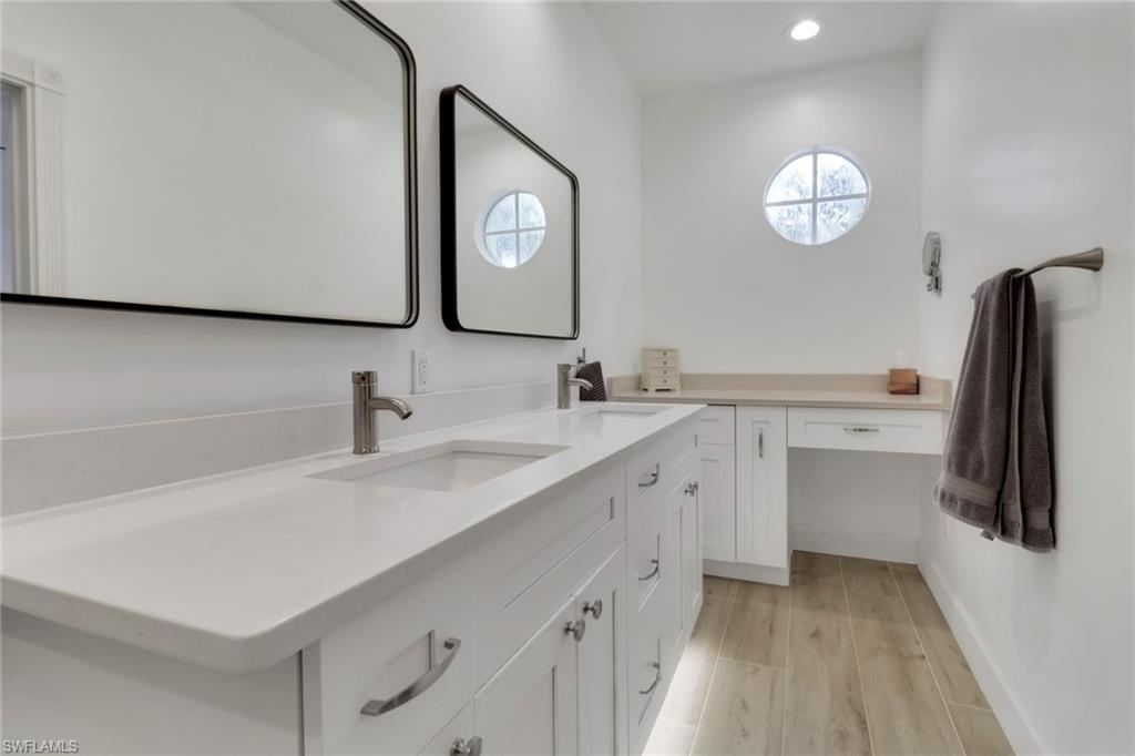 3570 Zanzibar Way Naples, FL 34119 - Photo 20 of 43 a bathroom with a sink a toilet and a mirror