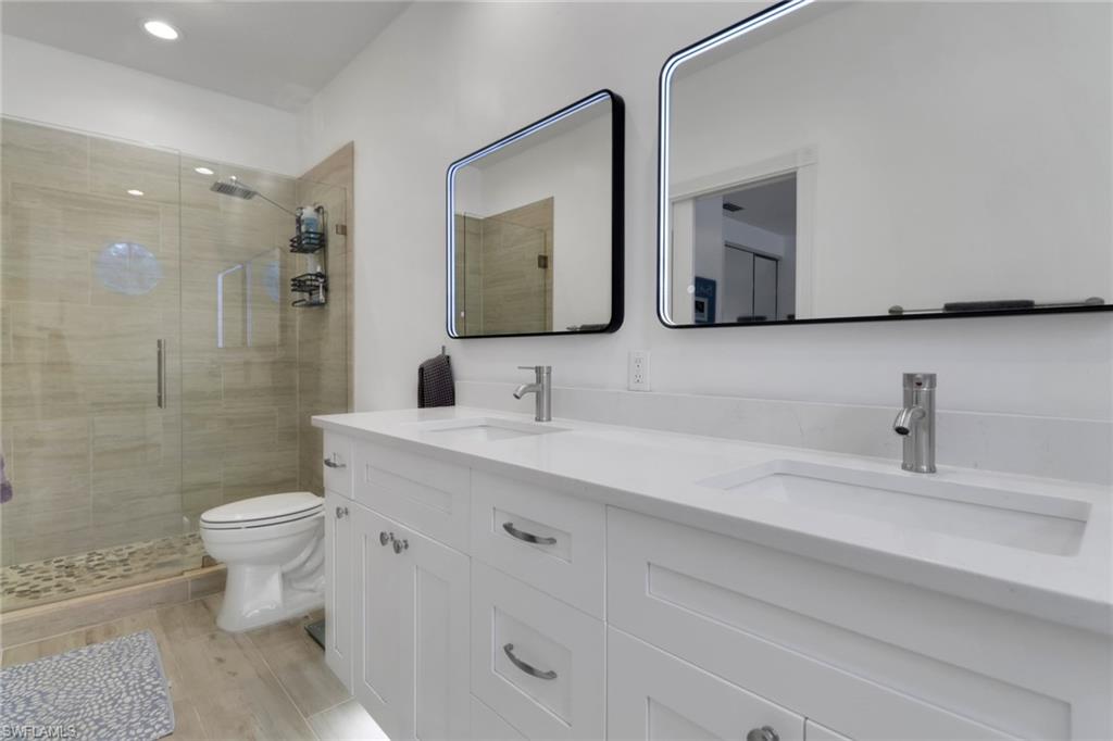3570 Zanzibar Way Naples, FL 34119 - Photo 21 of 43 a bathroom with a sink toilet and shower