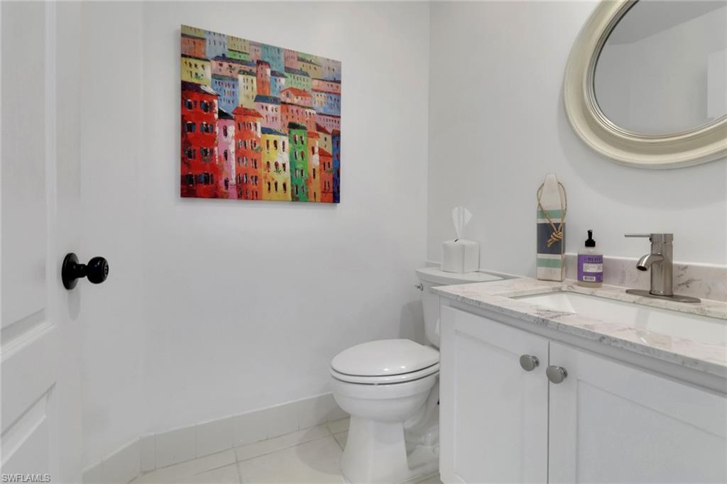 3570 Zanzibar Way Naples, FL 34119 - Photo 22 of 43 a bathroom with a toilet a sink and a mirror