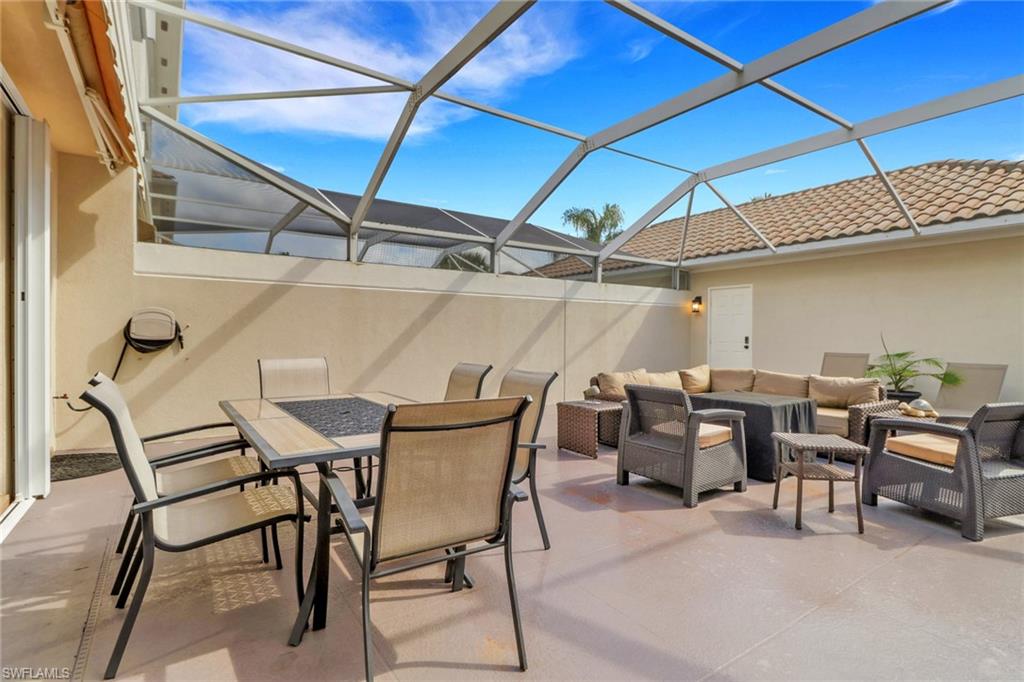 3570 Zanzibar Way Naples, FL 34119 - Photo 25 of 43 a view of an outdoor space with a table and chairs