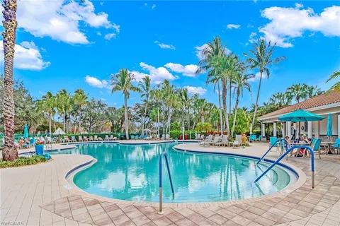 a swimming pool with outdoor seating and yard