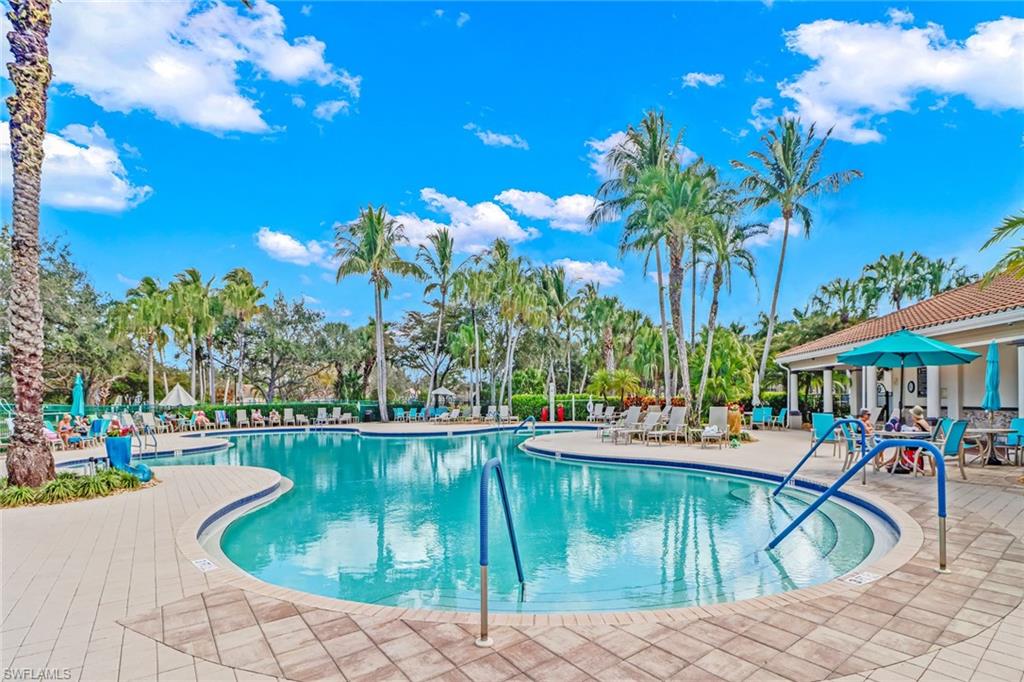 3570 Zanzibar Way Naples, FL 34119 - Photo 28 of 43 a swimming pool with outdoor seating and yard