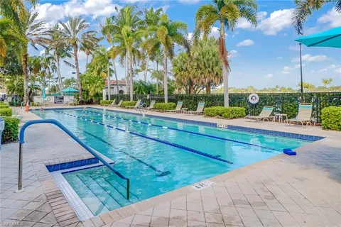 a view of swimming pool with a lounge chairs