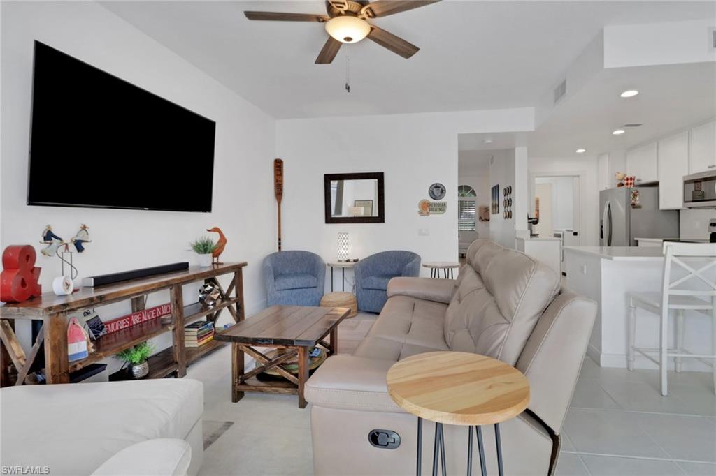 3570 Zanzibar Way Naples, FL 34119 - Photo 9 of 43 a living room with furniture and a flat screen tv