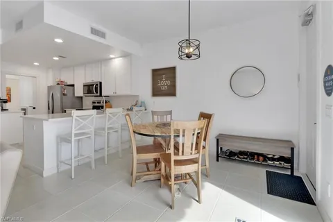 a dining room with furniture and a mirror
