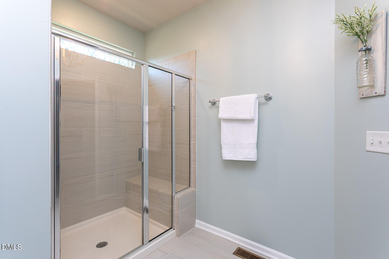 6197 Beale Loop Raleigh, NC 27616 - Photo 11 of 20 a bathroom with a glass shower door