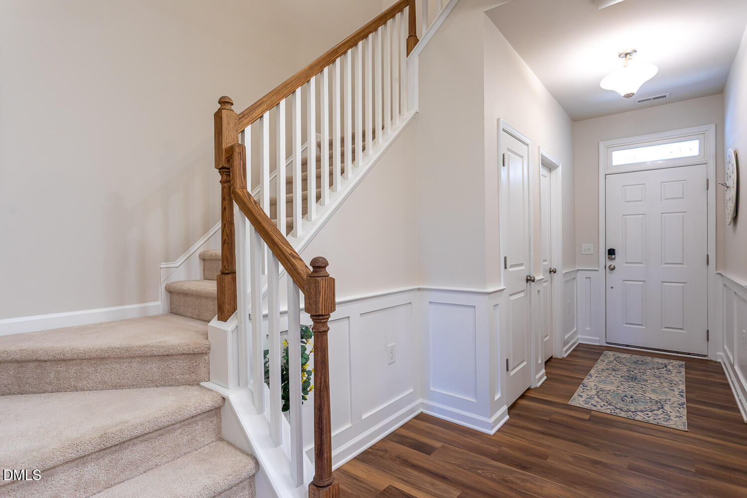 6197 Beale Loop Raleigh, NC 27616 - Photo 3 of 20 a view of entryway with wooden floor and stairs