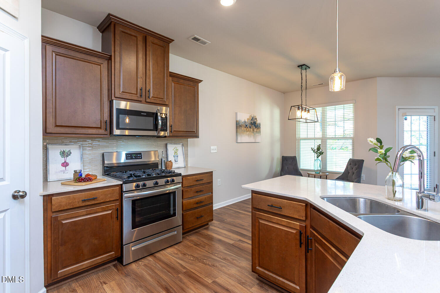 6197 Beale Loop Raleigh, NC 27616 - Photo 4 of 20 a kitchen with stainless steel appliances granite countertop a sink stove and refrigerator