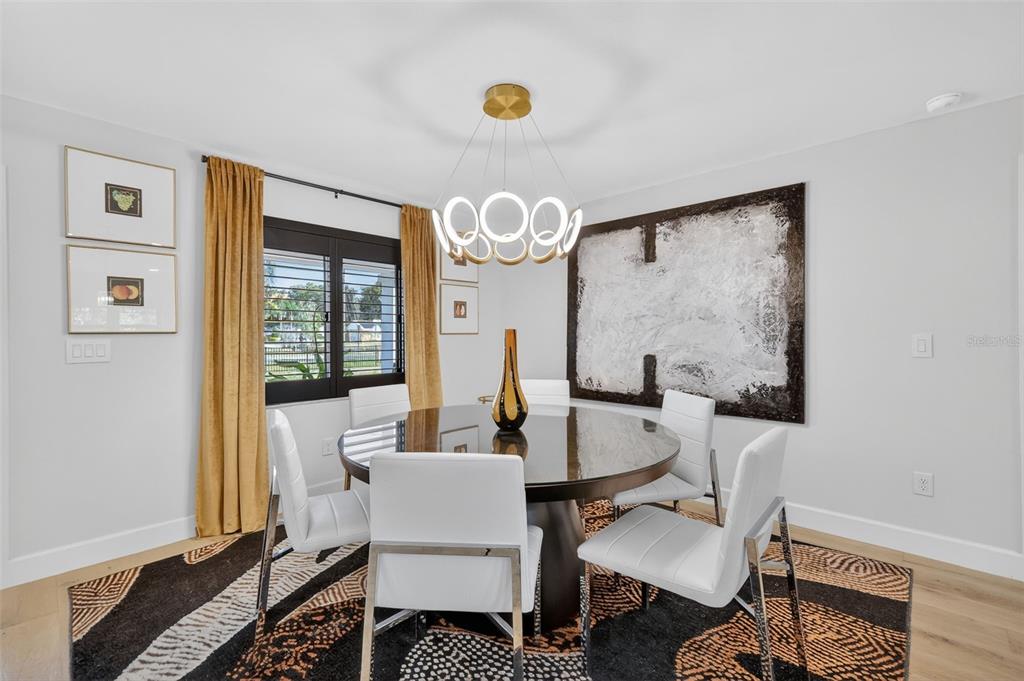 241 Bay Road Mount Dora, FL 32757 - Photo 12 of 57 a living room with furniture a table and a large window