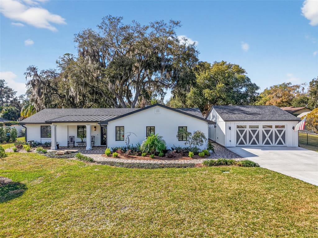 241 Bay Road Mount Dora, FL 32757 - Photo 2 of 57 a front view of a house with swimming pool and outdoor seating
