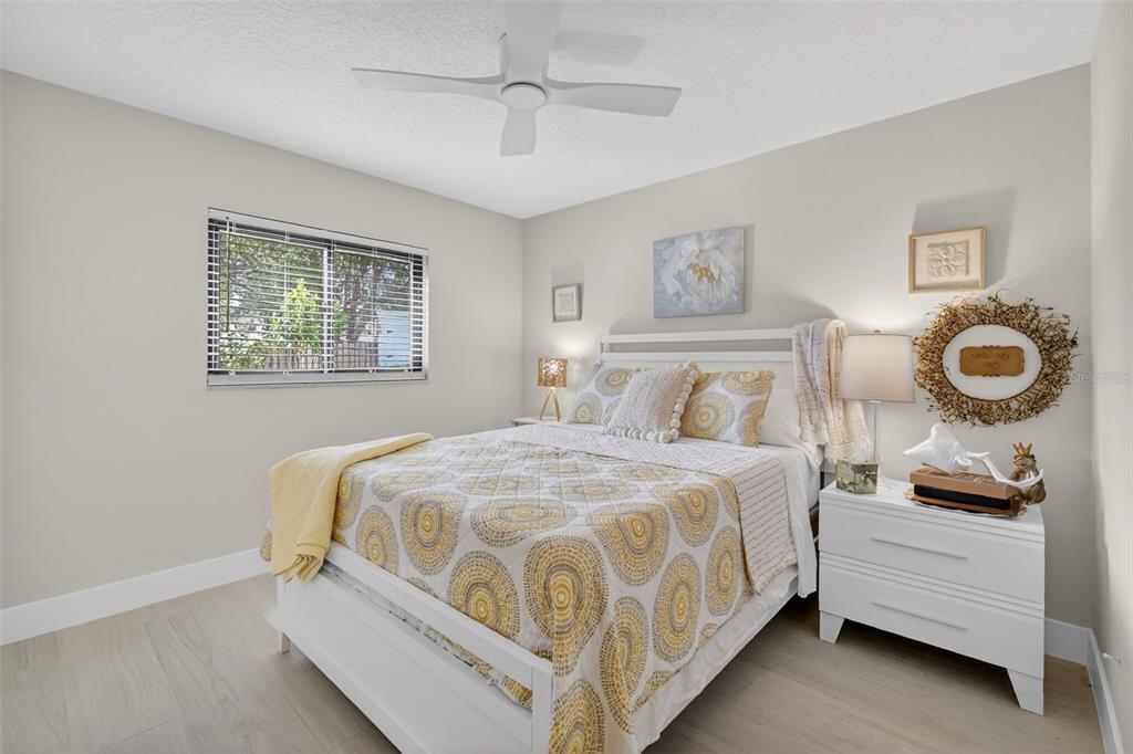 241 Bay Road Mount Dora, FL 32757 - Photo 25 of 57 a bedroom with a bed and lamp