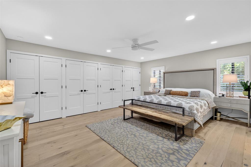 241 Bay Road Mount Dora, FL 32757 - Photo 27 of 57 a spacious bedroom with a bed and a flat screen tv