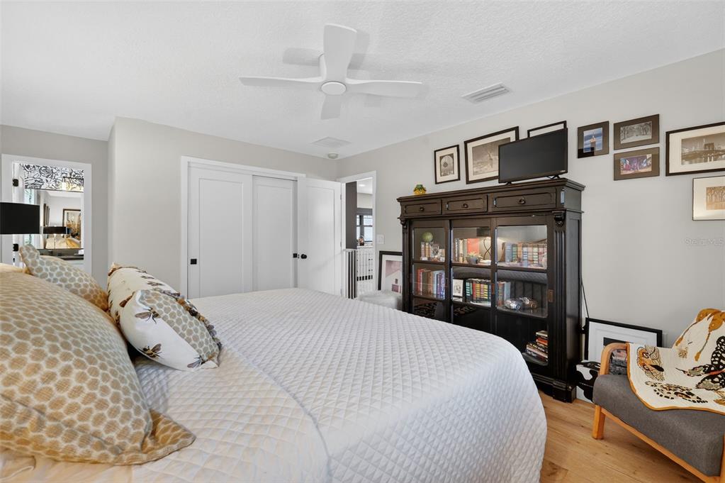 241 Bay Road Mount Dora, FL 32757 - Photo 32 of 57 a bedroom with a bed a dresser and a book shelf
