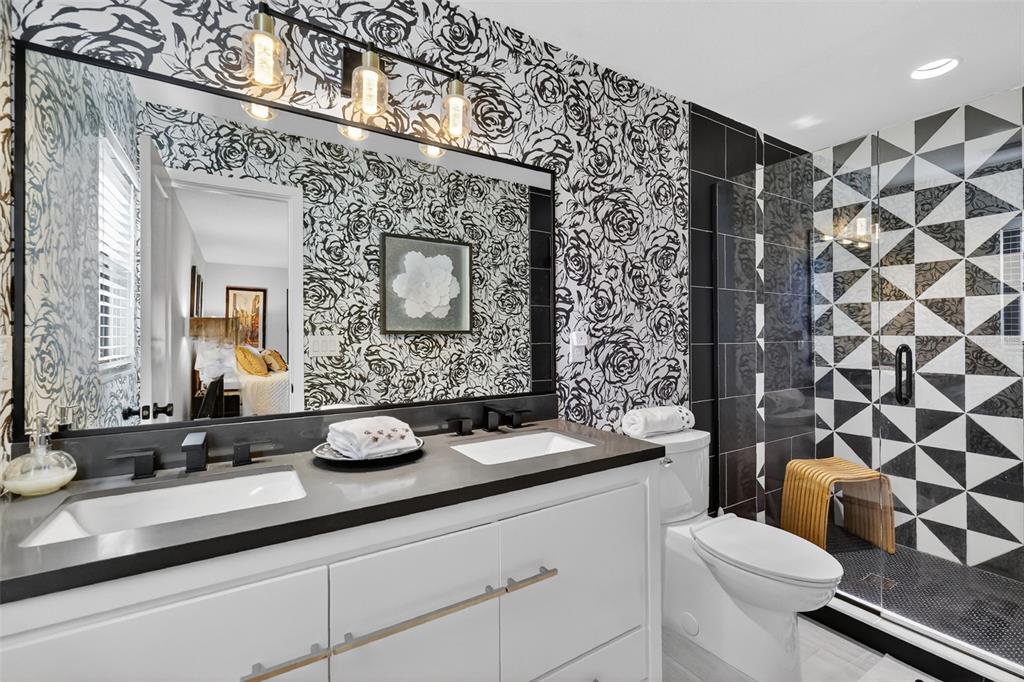 241 Bay Road Mount Dora, FL 32757 - Photo 34 of 57 a bathroom with a granite countertop toilet a sink and a mirror