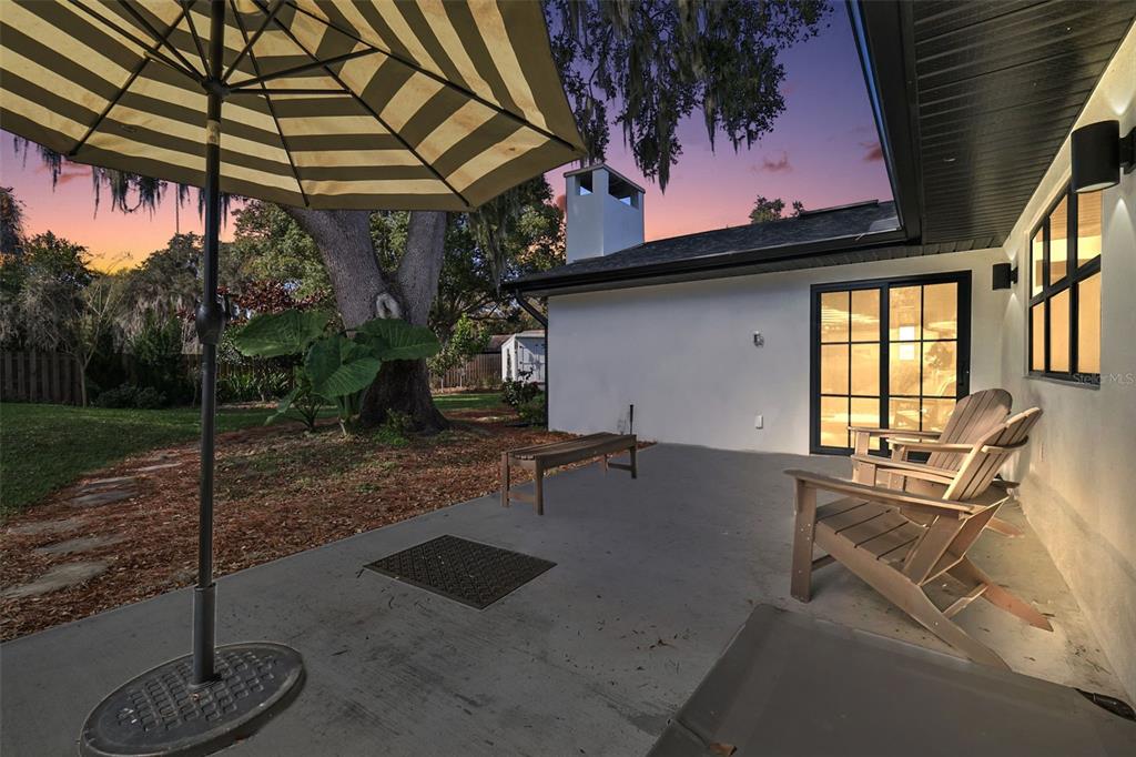 241 Bay Road Mount Dora, FL 32757 - Photo 39 of 57 a backyard of a house with table and chairs