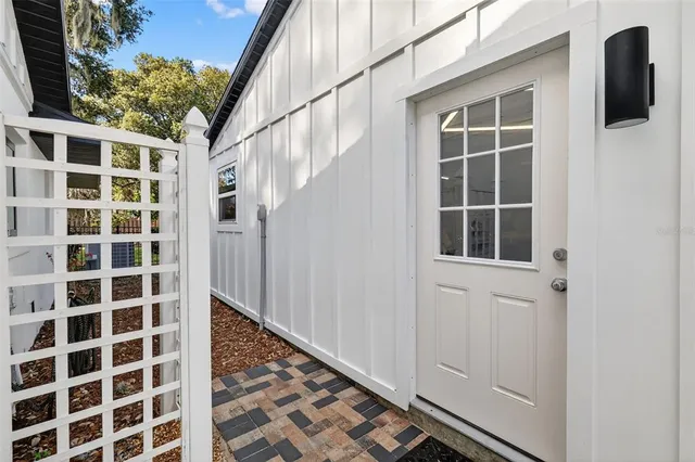 a view of swimming pool with seating area and trees in the background