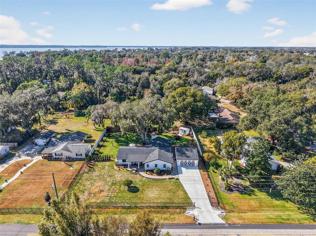 241 Bay Road Mount Dora, FL 32757 - Photo 51 of 57 a view of swimming pool with seating area and trees in the background