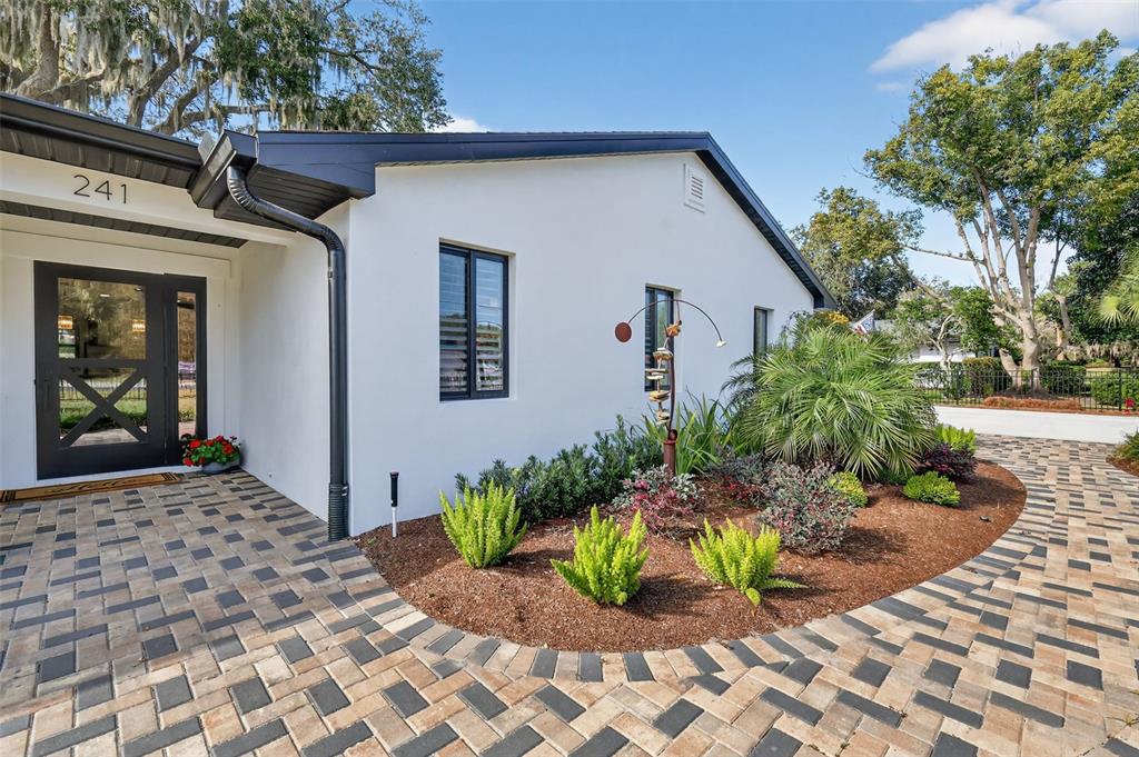 241 Bay Road Mount Dora, FL 32757 - Photo 9 of 57 a bunch of flowers in front of house