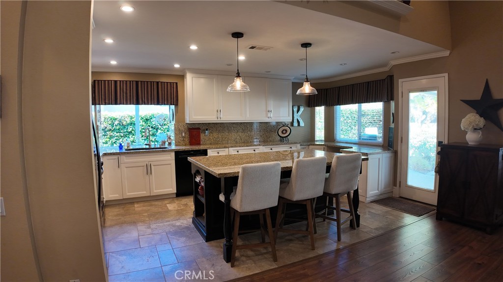 43080 Vista Del Rancho Temecula, CA 92592 - Photo 12 of 57 a kitchen with kitchen island granite countertop a sink counter and chairs