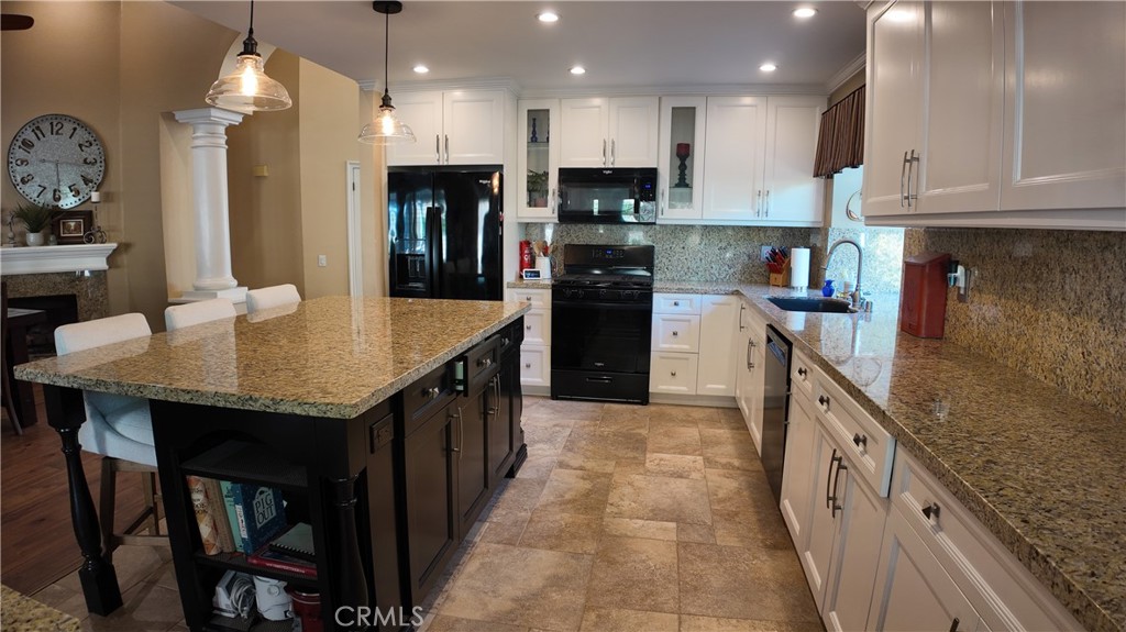 43080 Vista Del Rancho Temecula, CA 92592 - Photo 14 of 57 a kitchen with kitchen island granite countertop a sink a counter top space and stainless steel appliances
