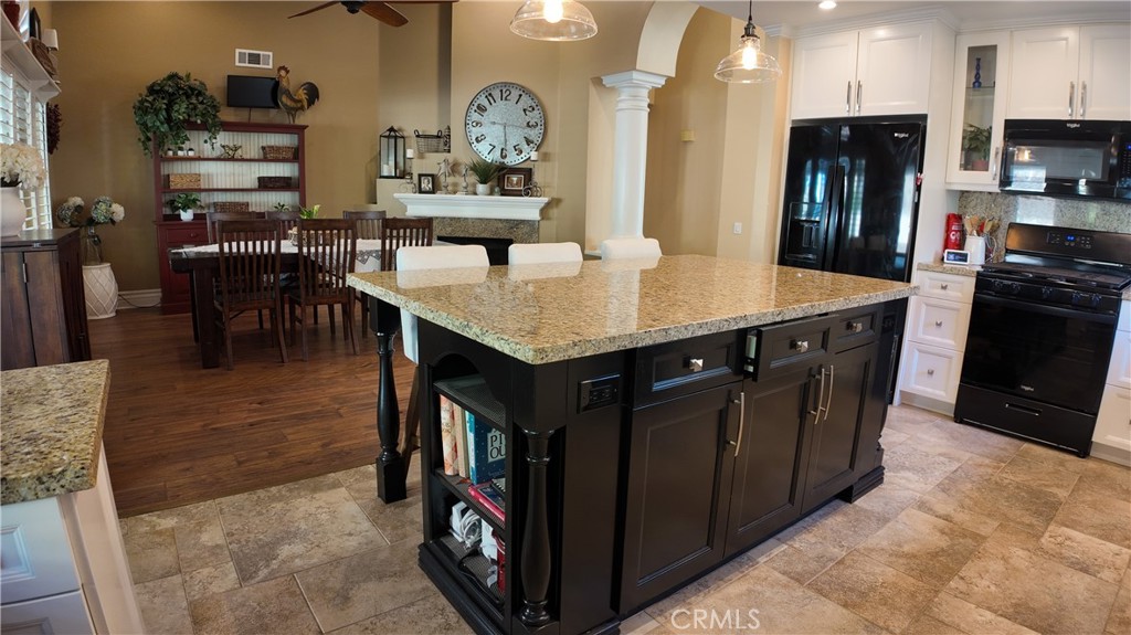 43080 Vista Del Rancho Temecula, CA 92592 - Photo 15 of 57 a kitchen with stainless steel appliances granite countertop a table chairs and a refrigerator