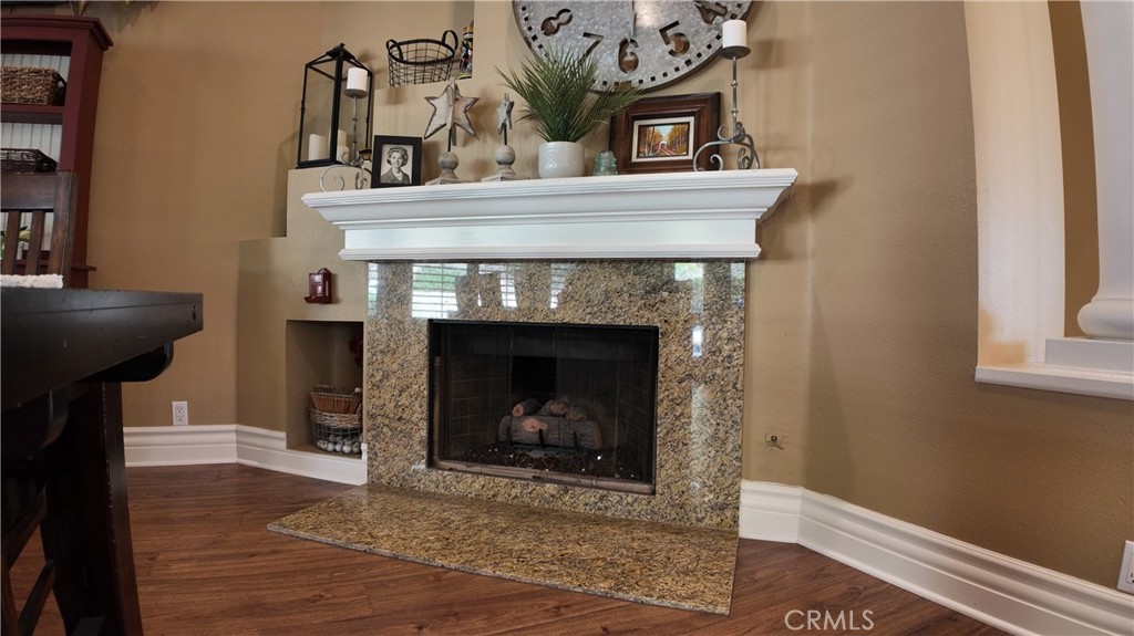 43080 Vista Del Rancho Temecula, CA 92592 - Photo 17 of 57 a living room with a fireplace and a wooden floor