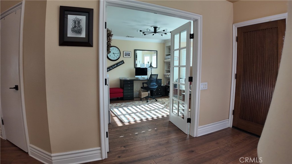 43080 Vista Del Rancho Temecula, CA 92592 - Photo 20 of 57 a view of a hallway to a livingroom with wooden floor and furniture