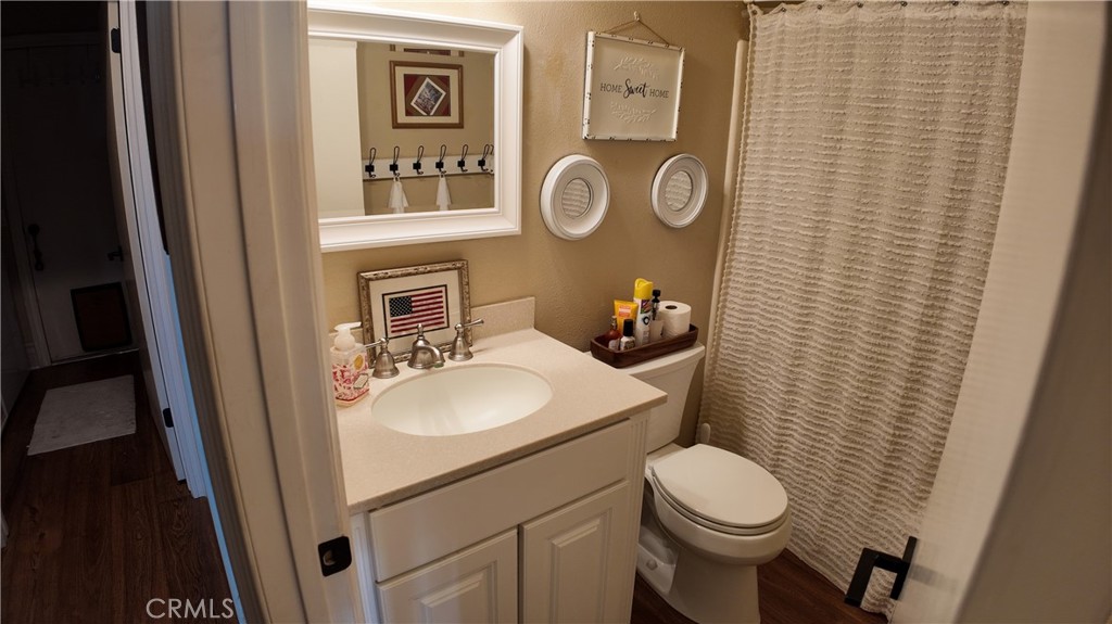 43080 Vista Del Rancho Temecula, CA 92592 - Photo 31 of 57 a bathroom with a toilet sink vanity and mirror