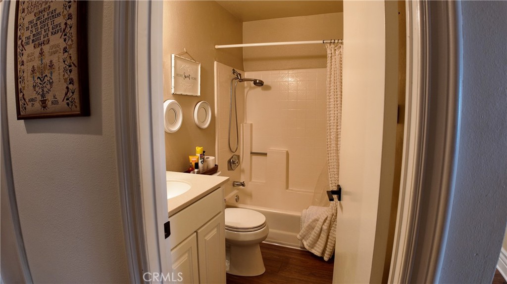 43080 Vista Del Rancho Temecula, CA 92592 - Photo 32 of 57 a bathroom with a granite countertop toilet a sink and a mirror