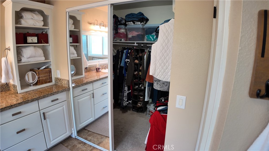 43080 Vista Del Rancho Temecula, CA 92592 - Photo 43 of 57 a view of walk in closet with clothes and shoes