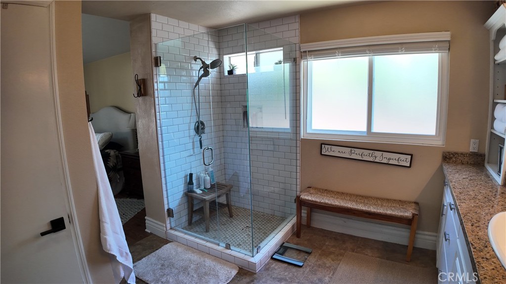 43080 Vista Del Rancho Temecula, CA 92592 - Photo 46 of 57 a bathroom with a sink a mirror and a shower