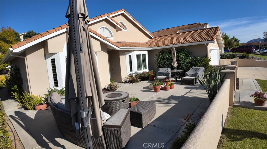 43080 Vista Del Rancho Temecula, CA 92592 - Photo 5 of 57 a view of a patio with couches chairs potted plants and floor to ceiling window
