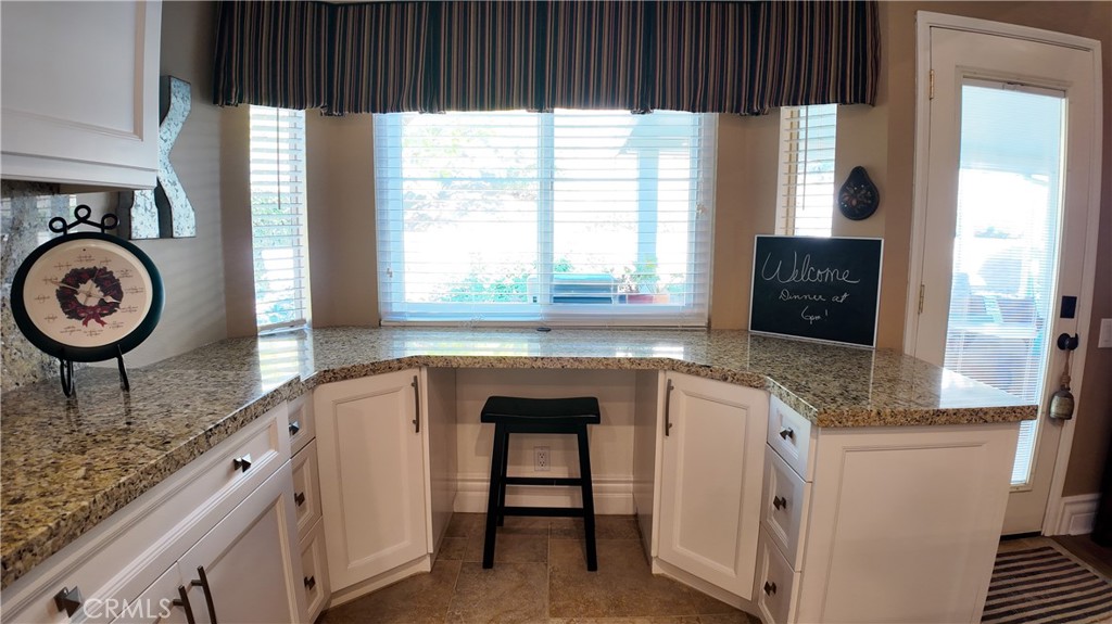 43080 Vista Del Rancho Temecula, CA 92592 - Photo 56 of 57 a kitchen with granite countertop a sink a stove and cabinets