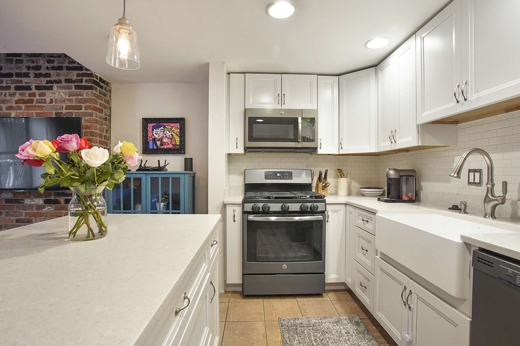 1670 Washington Street, Unit 6 Boston, MA 02118 - Photo 1 of 17 a kitchen with granite countertop a sink stainless steel appliances and cabinets