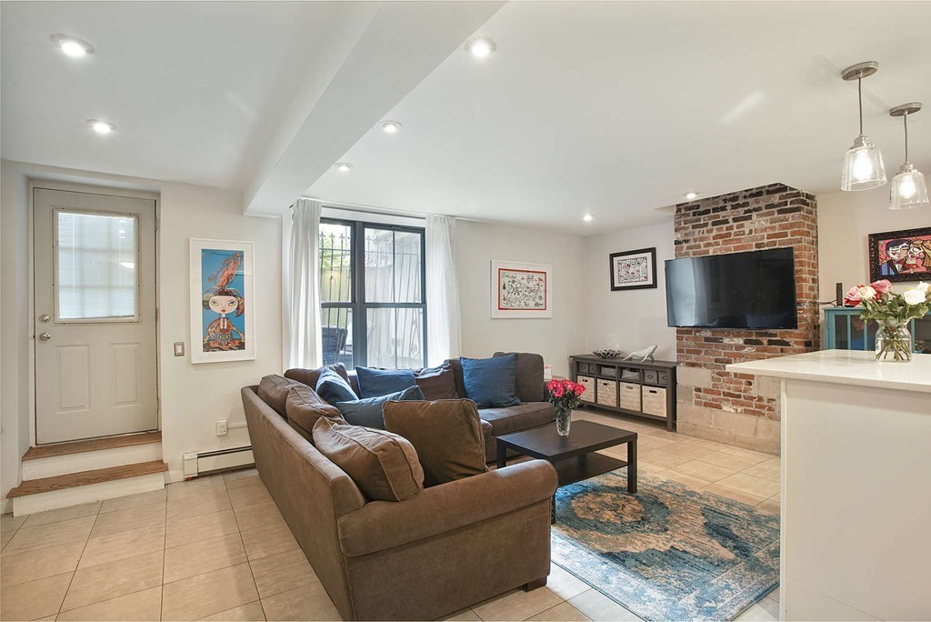 1670 Washington Street, Unit 6 Boston, MA 02118 - Photo 2 of 17 a living room with furniture and a flat screen tv