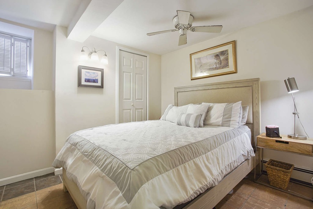 1670 Washington Street, Unit 6 Boston, MA 02118 - Photo 7 of 17 a bedroom with a bed and wall painting