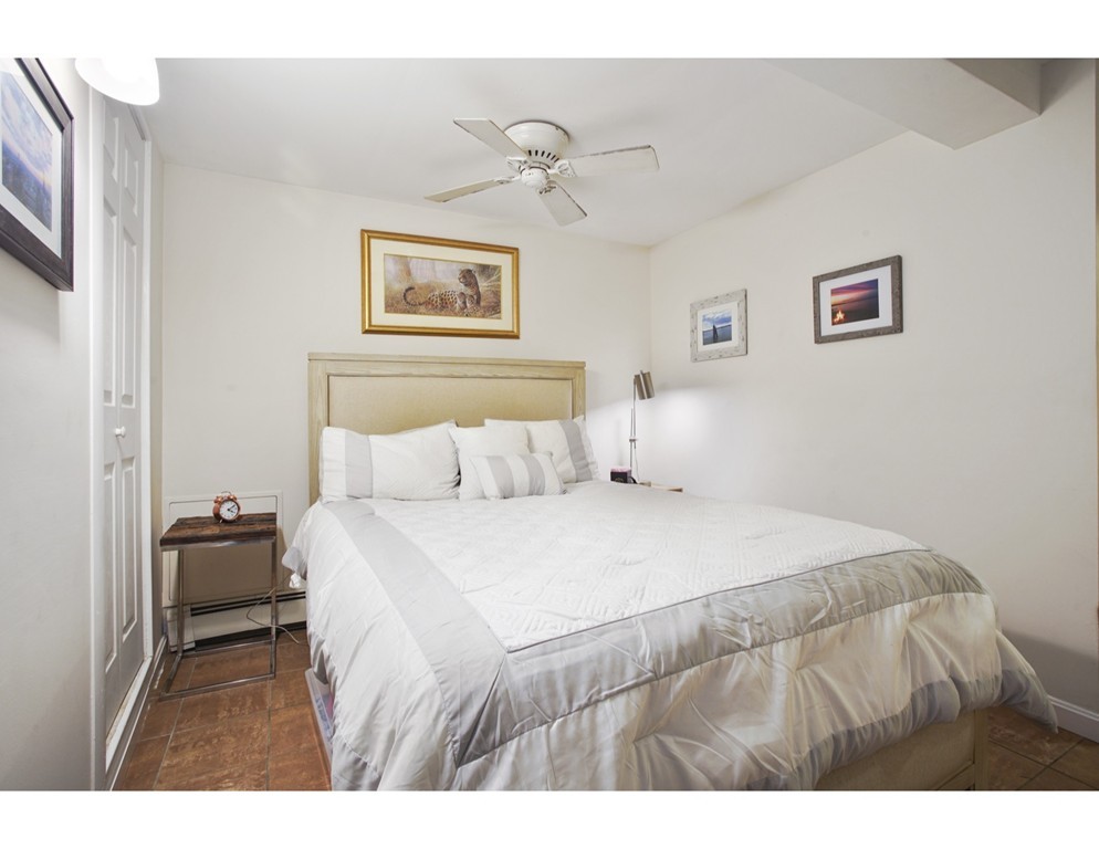 1670 Washington Street, Unit 6 Boston, MA 02118 - Photo 8 of 17 a bedroom with a bed and a tv