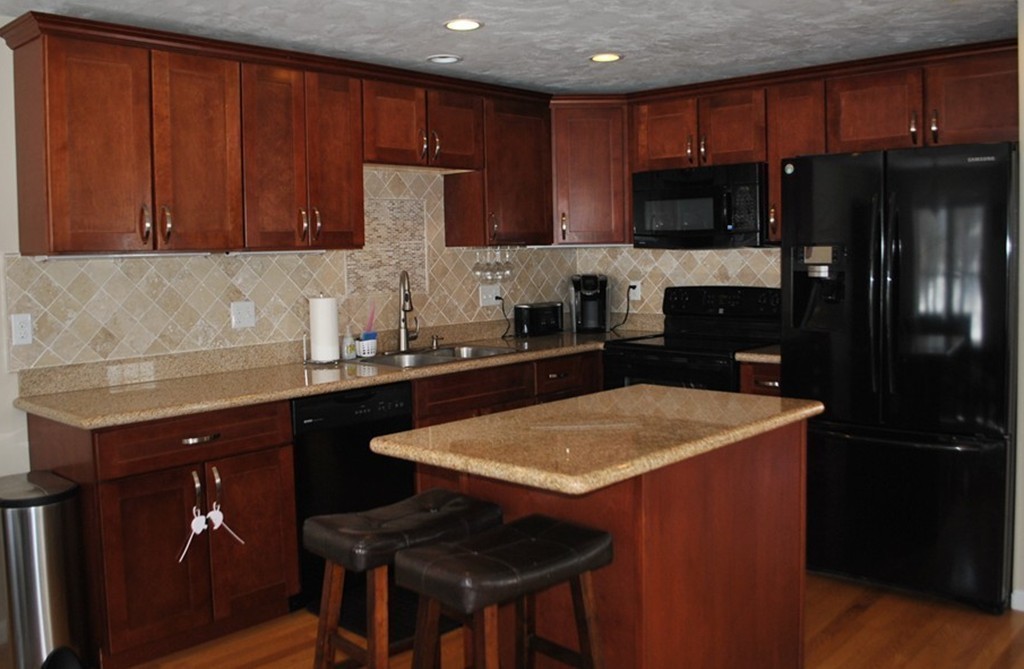 8 Honeysuckle Road Worcester, MA 01607 - Photo 10 of 27 a kitchen with a sink refrigerator and cabinets