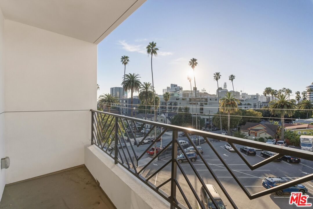 1759 North Gower Street, Unit 404 Los Angeles, CA 90028 - Photo 11 of 23 a view of a balcony with wooden floor and fence