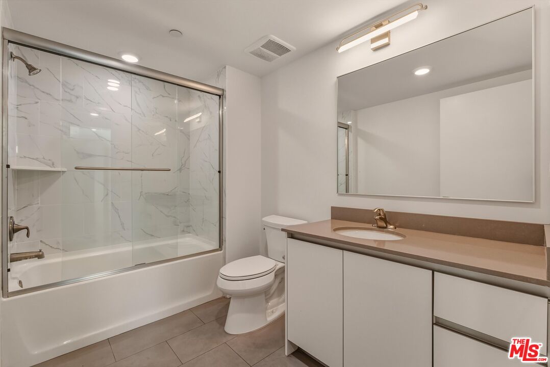 1759 North Gower Street, Unit 404 Los Angeles, CA 90028 - Photo 14 of 23 a bathroom with a sink toilet and shower