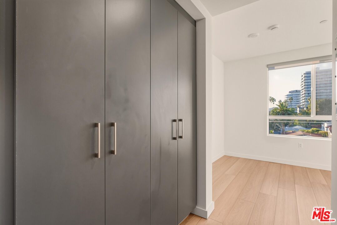 1759 North Gower Street, Unit 404 Los Angeles, CA 90028 - Photo 17 of 23 a view of an empty room with a window and wooden floor