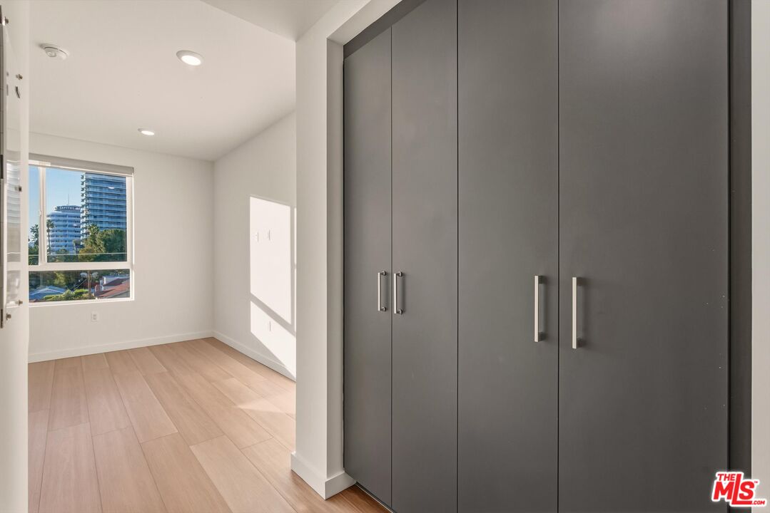 1759 North Gower Street, Unit 404 Los Angeles, CA 90028 - Photo 18 of 23 a view of an empty room with wooden floor and a window