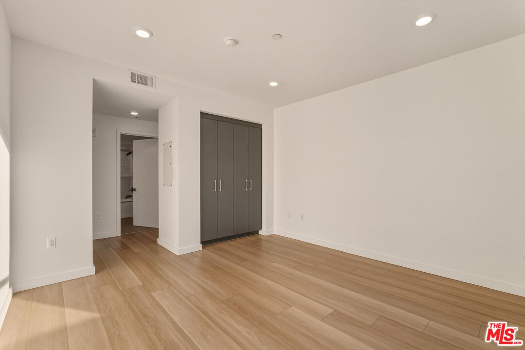1759 North Gower Street, Unit 404 Los Angeles, CA 90028 - Photo 20 of 23 an empty room with wooden floor and natural light