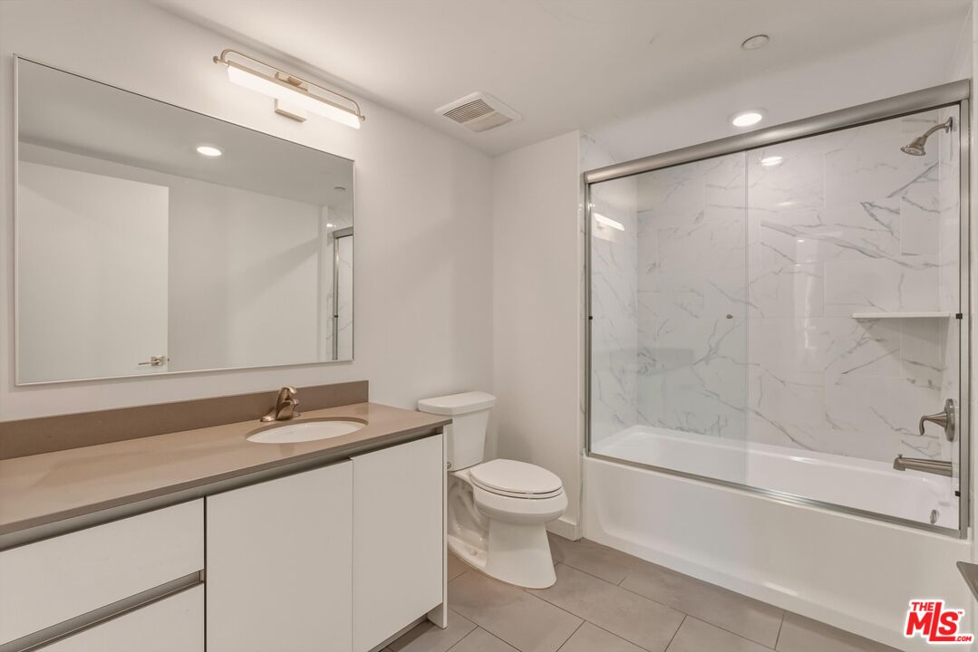 1759 North Gower Street, Unit 404 Los Angeles, CA 90028 - Photo 21 of 23 a bathroom with a sink a toilet and shower