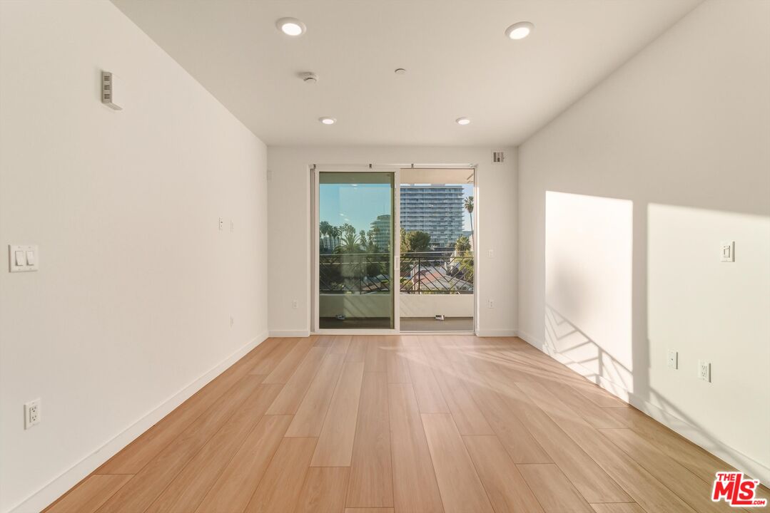 1759 North Gower Street, Unit 404 Los Angeles, CA 90028 - Photo 9 of 23 a view of an empty room with wooden floor
