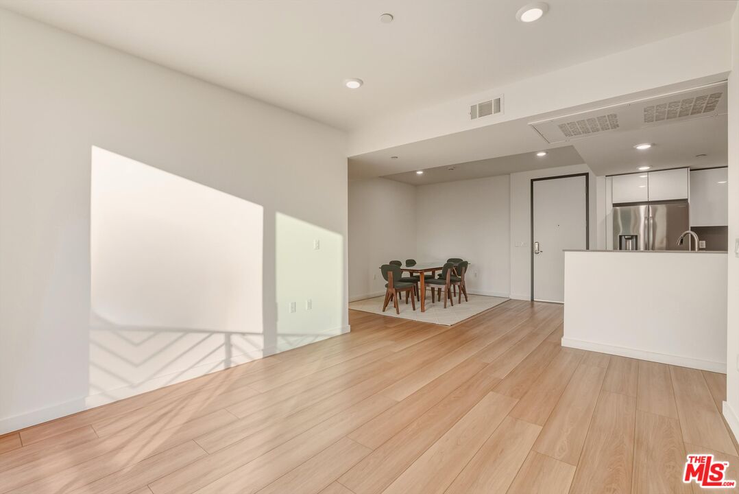 1759 North Gower Street, Unit 404 Los Angeles, CA 90028 - Photo 10 of 23 a view of a kitchen with furniture and wooden floor