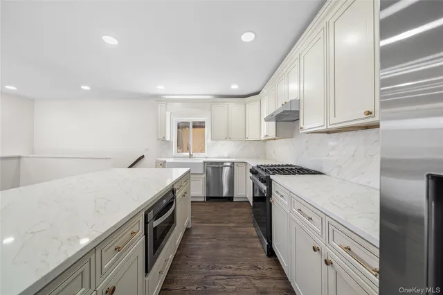 a kitchen with a sink stove and cabinets