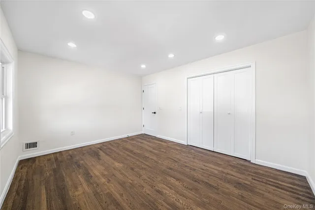an empty room with wooden floor